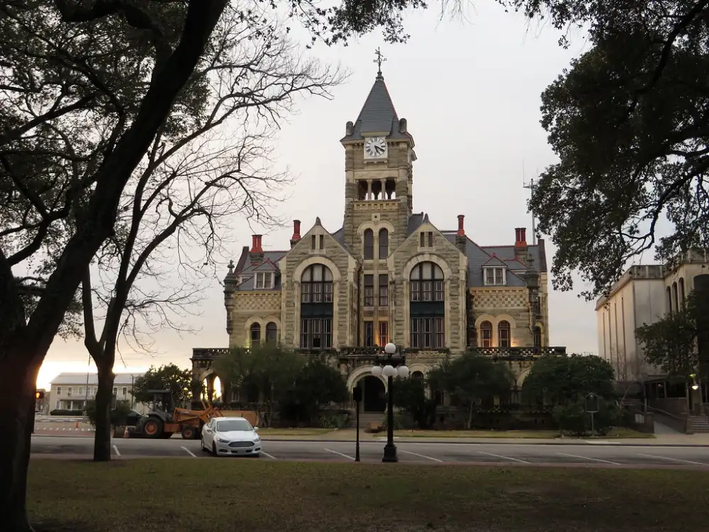 A grand historic courthouse building with intricate stone architecture and a clock tower.