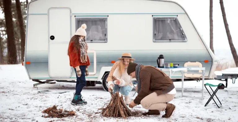 Family camping in snowy forest