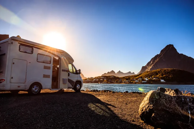 Camper van parked by mountain lake
