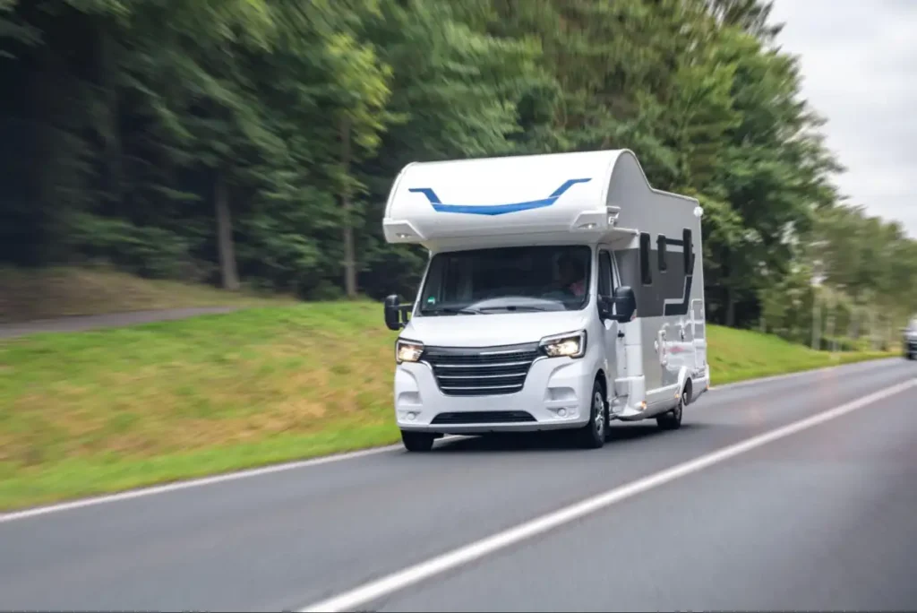 White motorhome driving along road