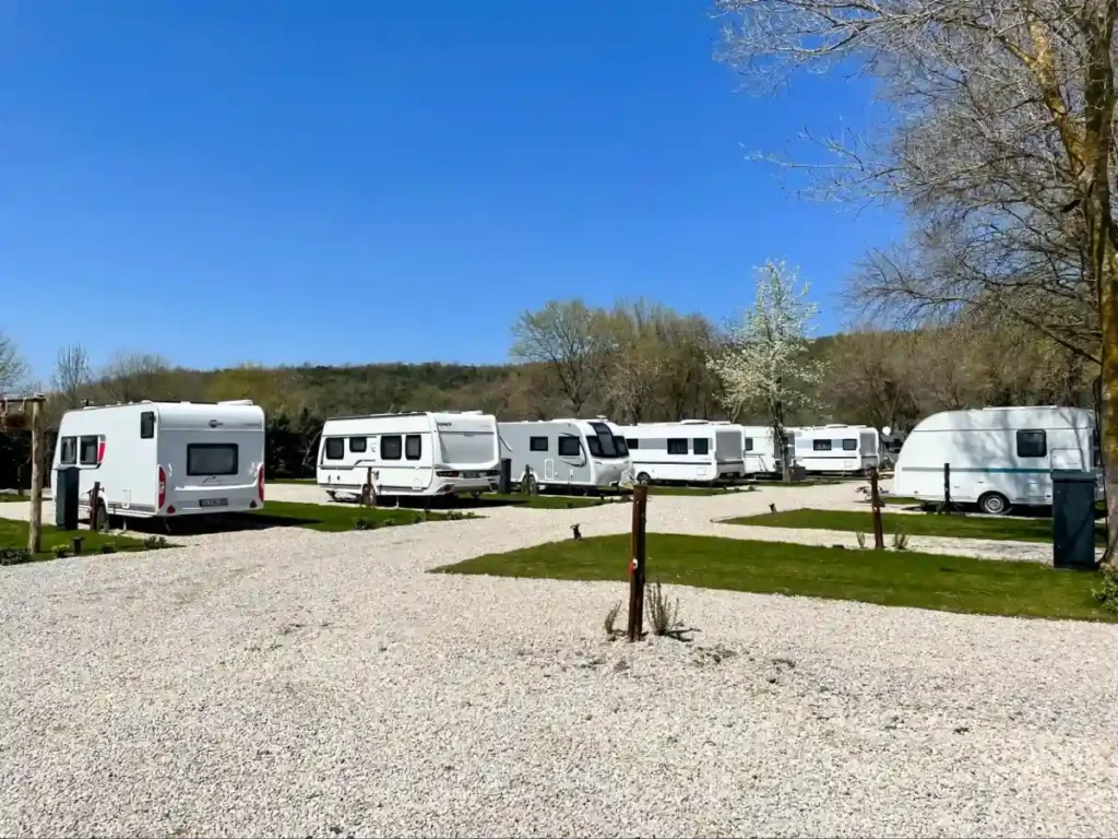 Peaceful RV campground with trailers and green spaces